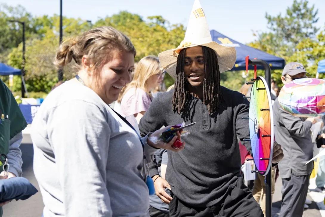 Photo of Researchpalooza attendee playing a wheel-spinning game