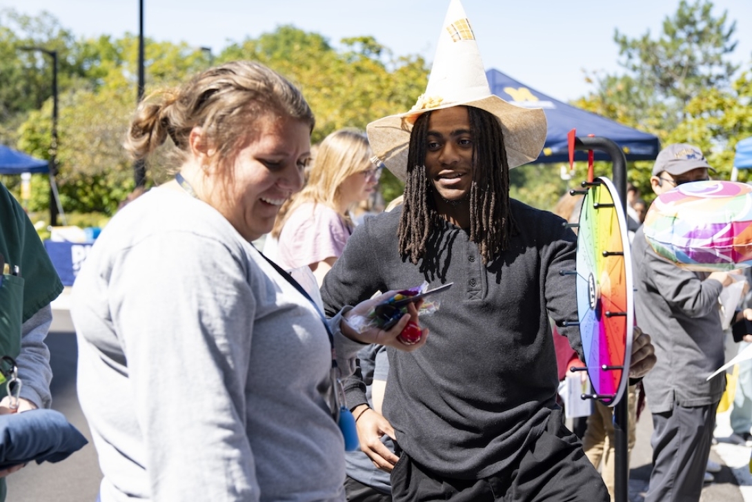 Photo of Researchpalooza attendee playing a wheel-spinning game