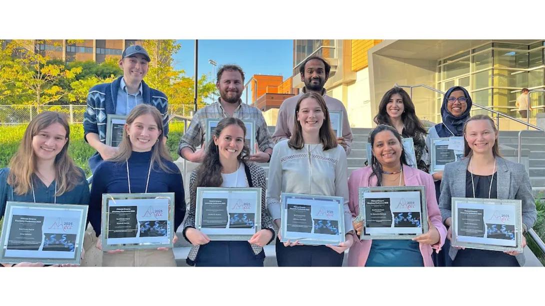 students holding award plaques