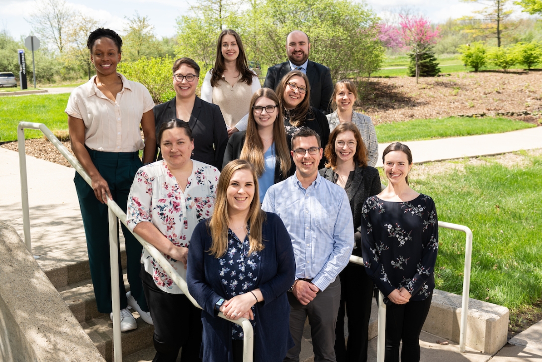 group of fellows standing outside on a bright spring day