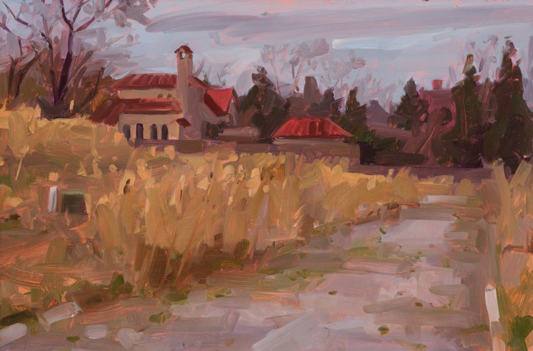 Impressionistic painting of a landscape with a small building and bell tower topped by red roofs, surrounded by dark trees and tall golden grasses, reflected in calm water beneath a soft pink and gray sky.