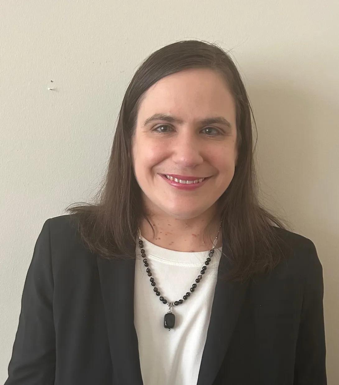 Beth Rivard smiling and wearing a black blazer.