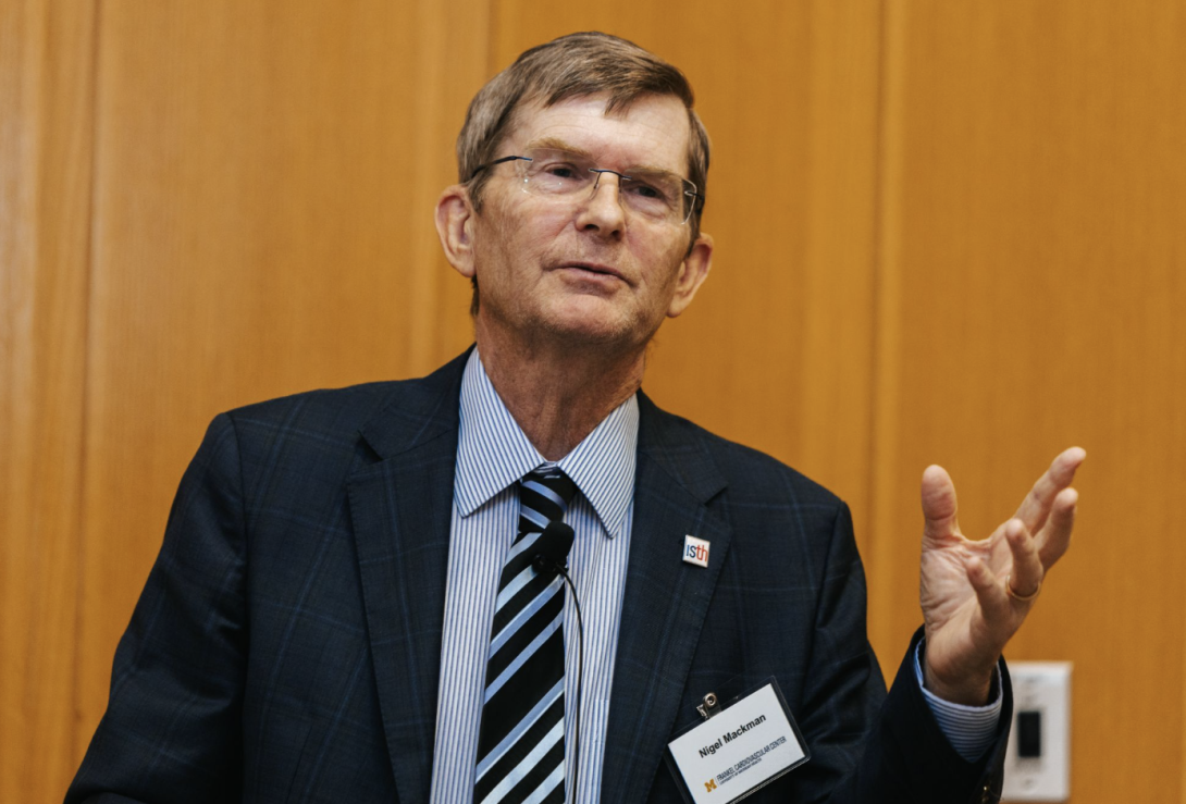 man presenting at a symposium