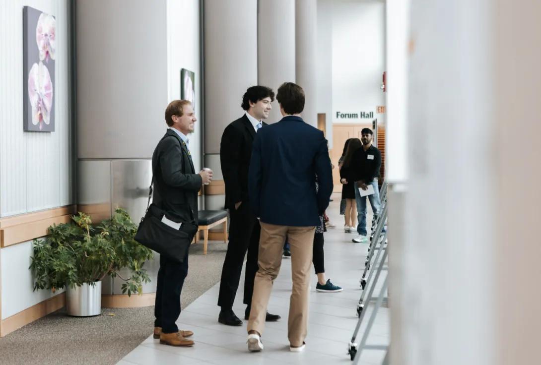 people talking at a poster presentation