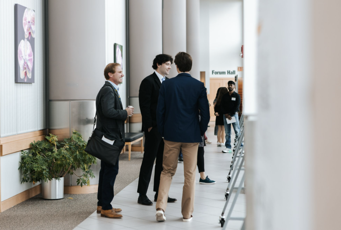 people talking at a poster presentation