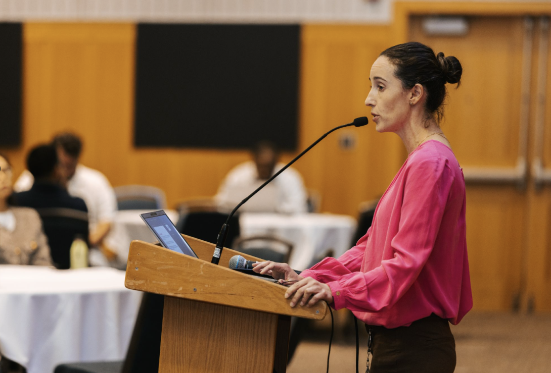 woman presenting at a symposium