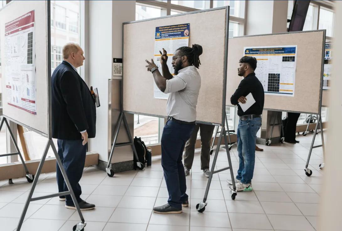 people talking at a poster presentation