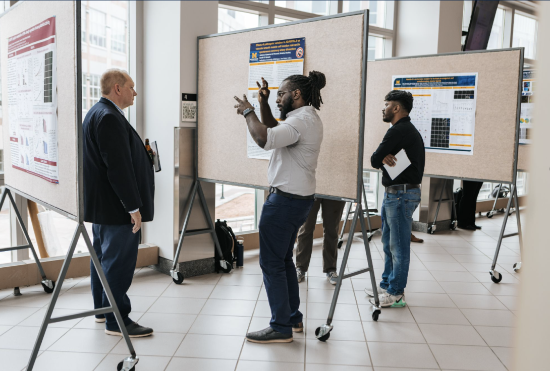 people talking at a poster presentation