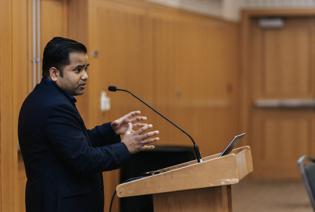 man presenting at a symposium