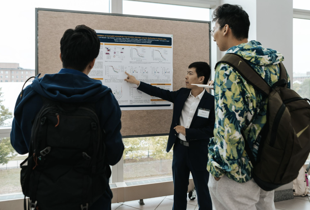 people talking at a poster presentation