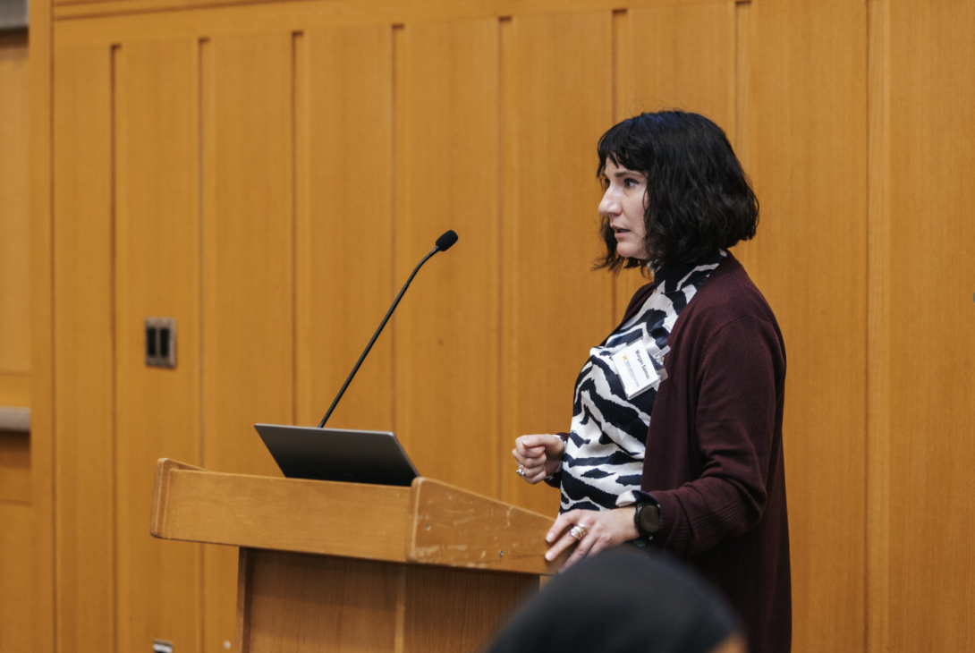 woman presenting at a symposium