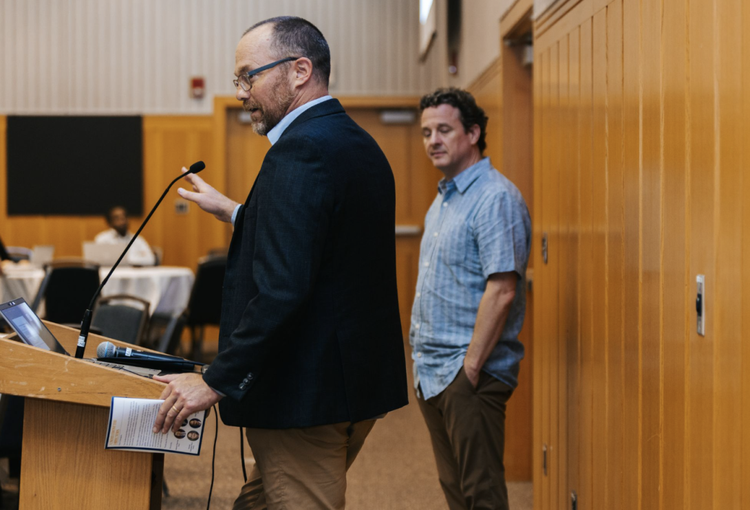 man presenting at a symposium