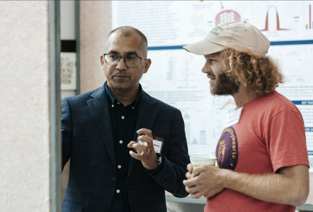 people talking at a poster presentation
