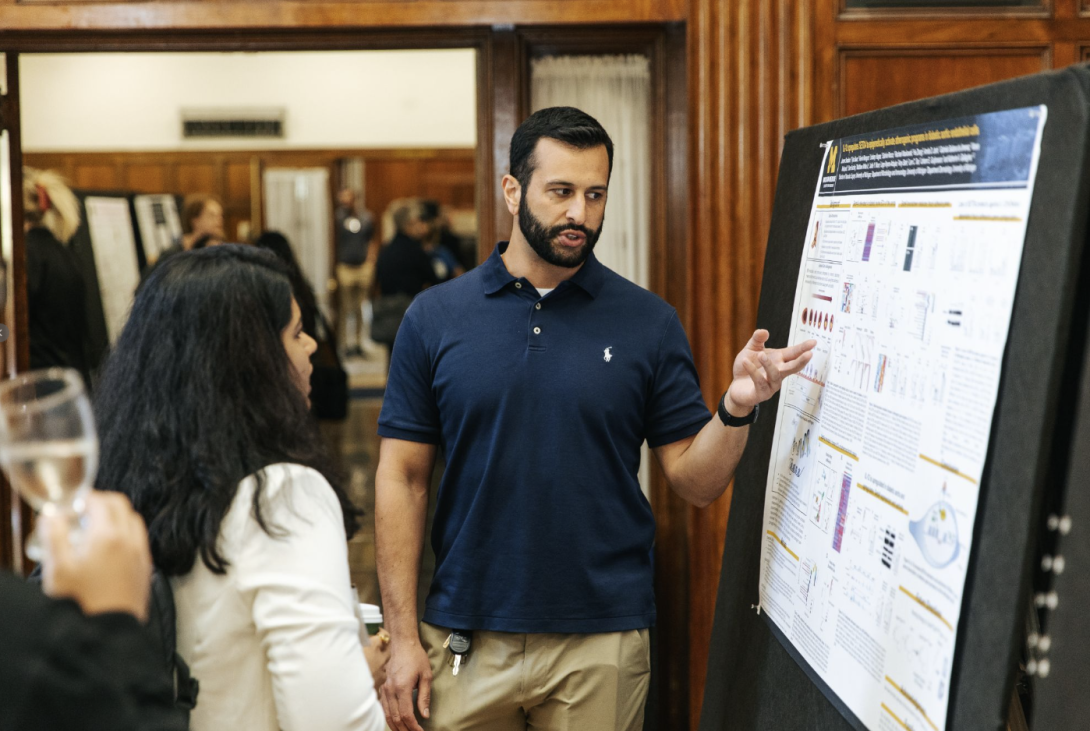 people talking at a poster presentation