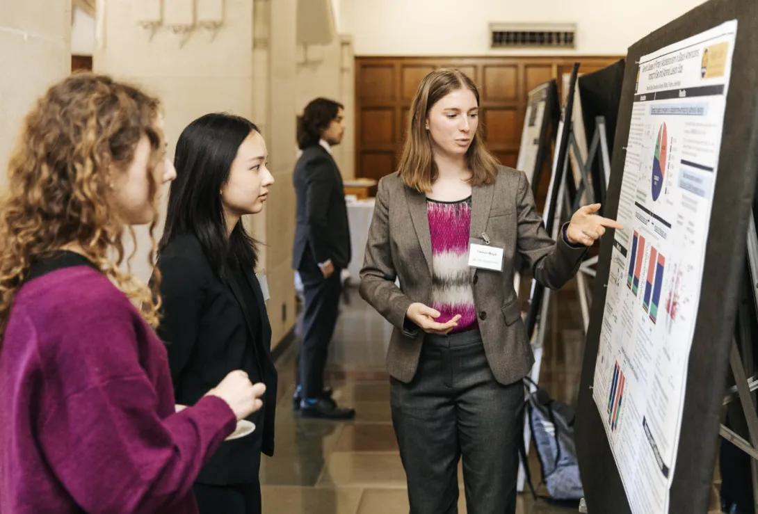 people talking at a poster presentation