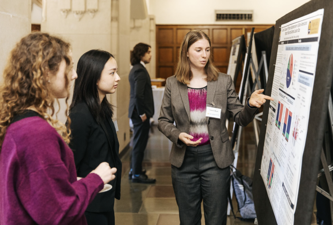 people talking at a poster presentation
