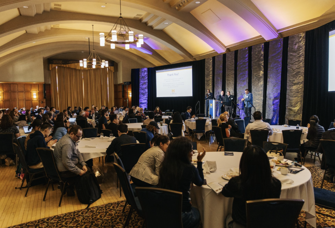 people sitting at round tables at an event
