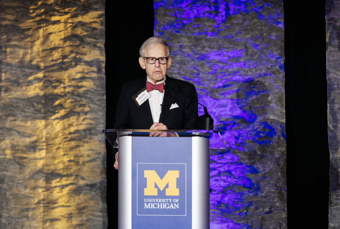 man presenting at a symposium