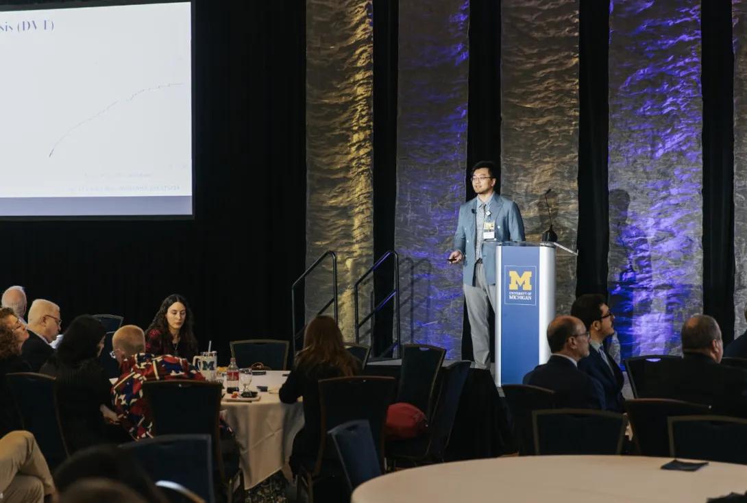 man presenting at a symposium