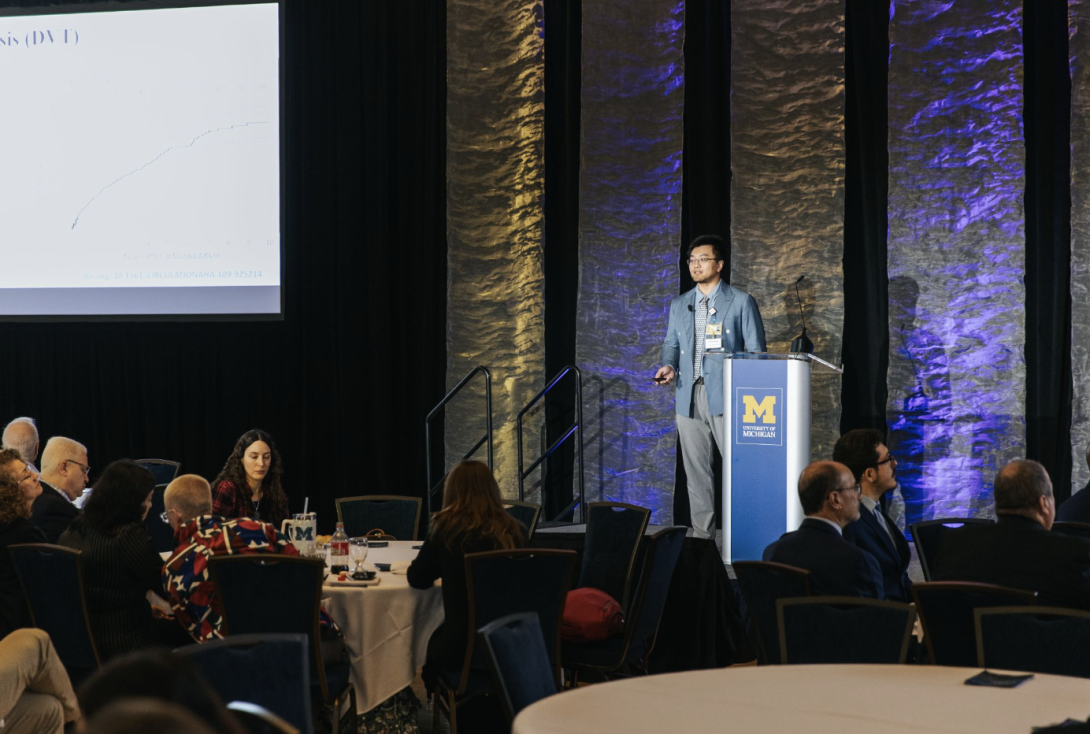 man presenting at a symposium