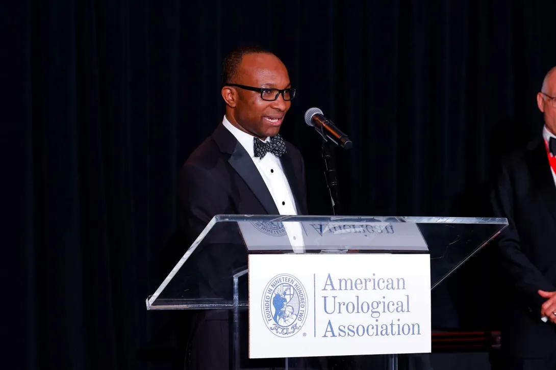 man excepting an award at a ceremony