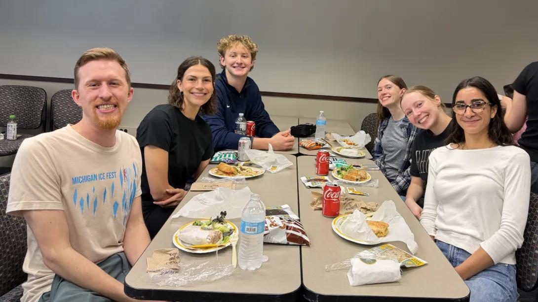 Several Biological Chemistry students enjoying lunch around a table