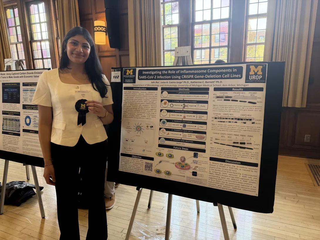 Picture of Juhi with her poster and award