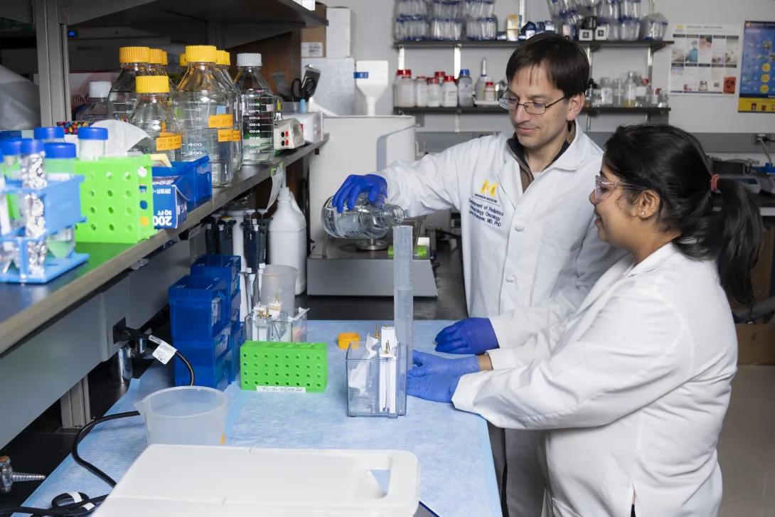 Dr. John Prensner and colleague in research lab