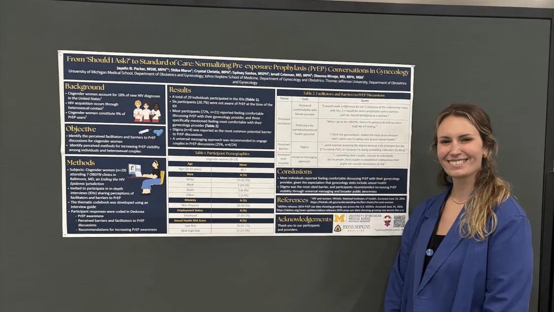 Reproductive Infectious Disease Research Group team member standing in front of research poster