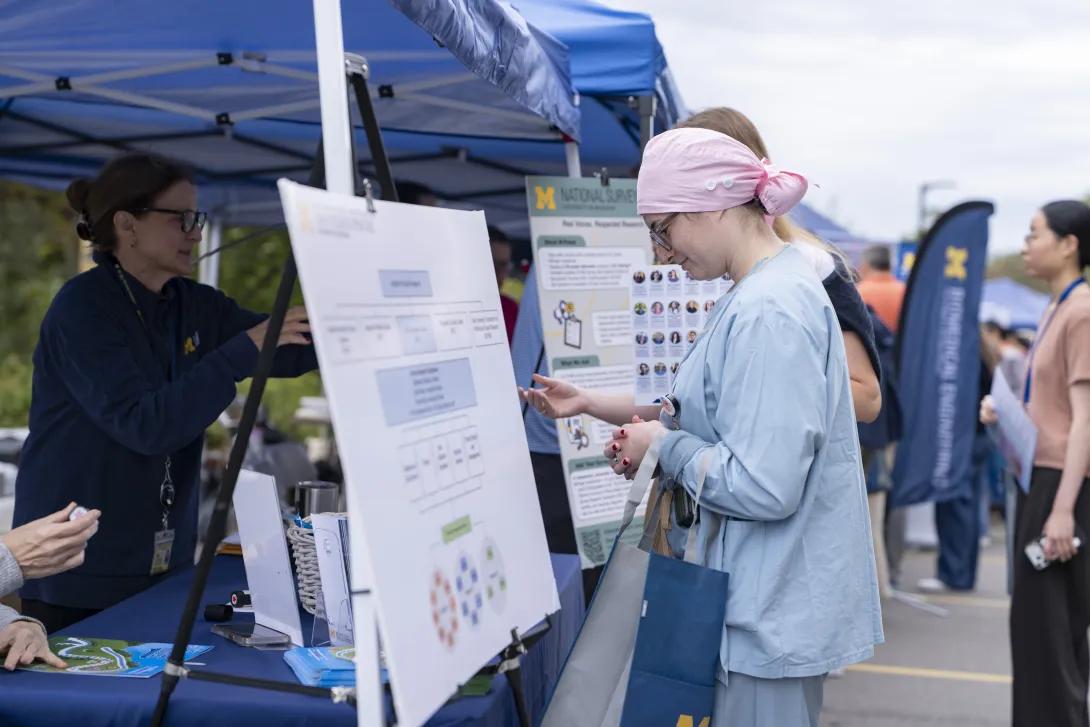 candid picture of people at a tabling event outdoors