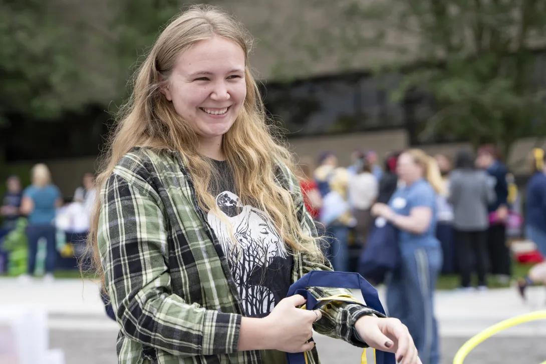 candid picture of person smiling at a tabling event outdoors