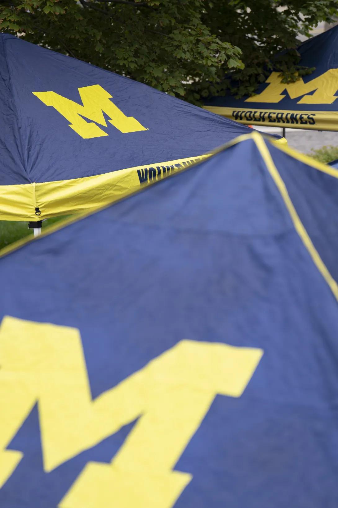 Block M, Michigan tents set up at a tabling event outdoors