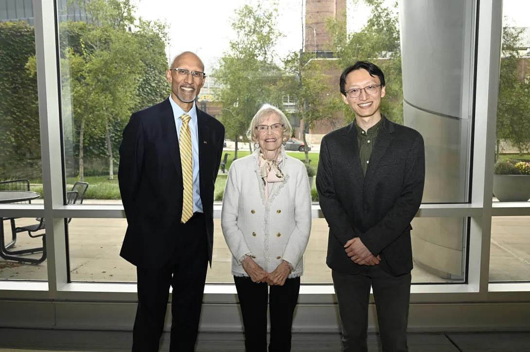 Yunlu Zhu (right) poses in front of a window with Shelley Barr (middle) and Ravi Allada (left)